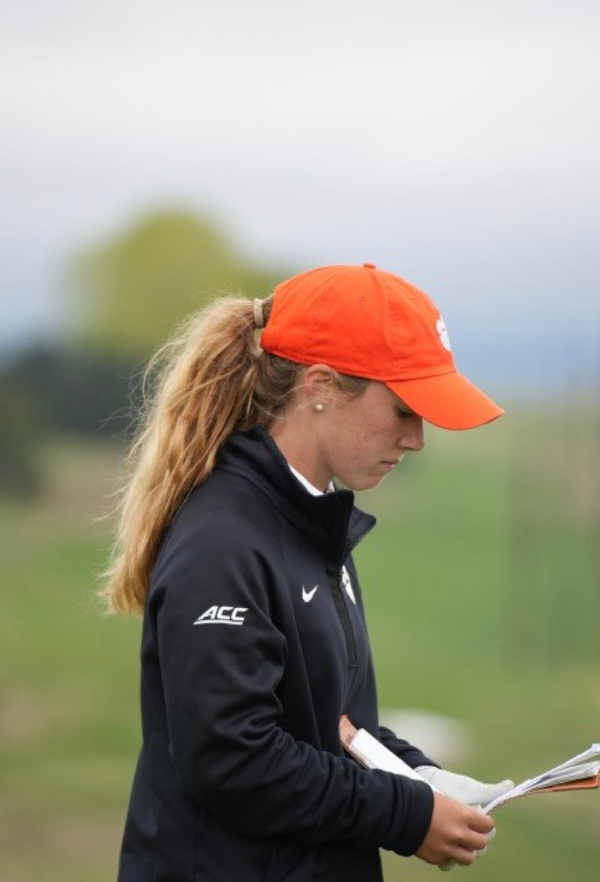 Chloe Holder reading her yardage book to plan a shot