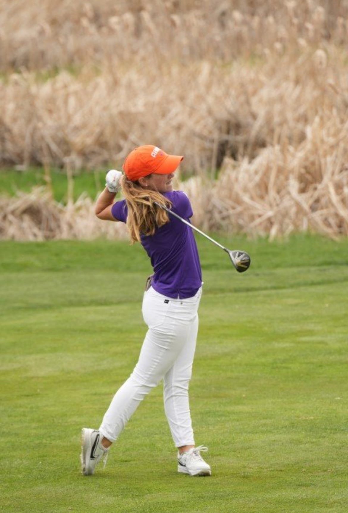Chloe Holder's swing follow-through in Clemson purple